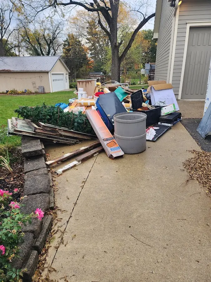 Dumpster being loaded with debris for Demolition Dumpster Rental in East Grand Forks